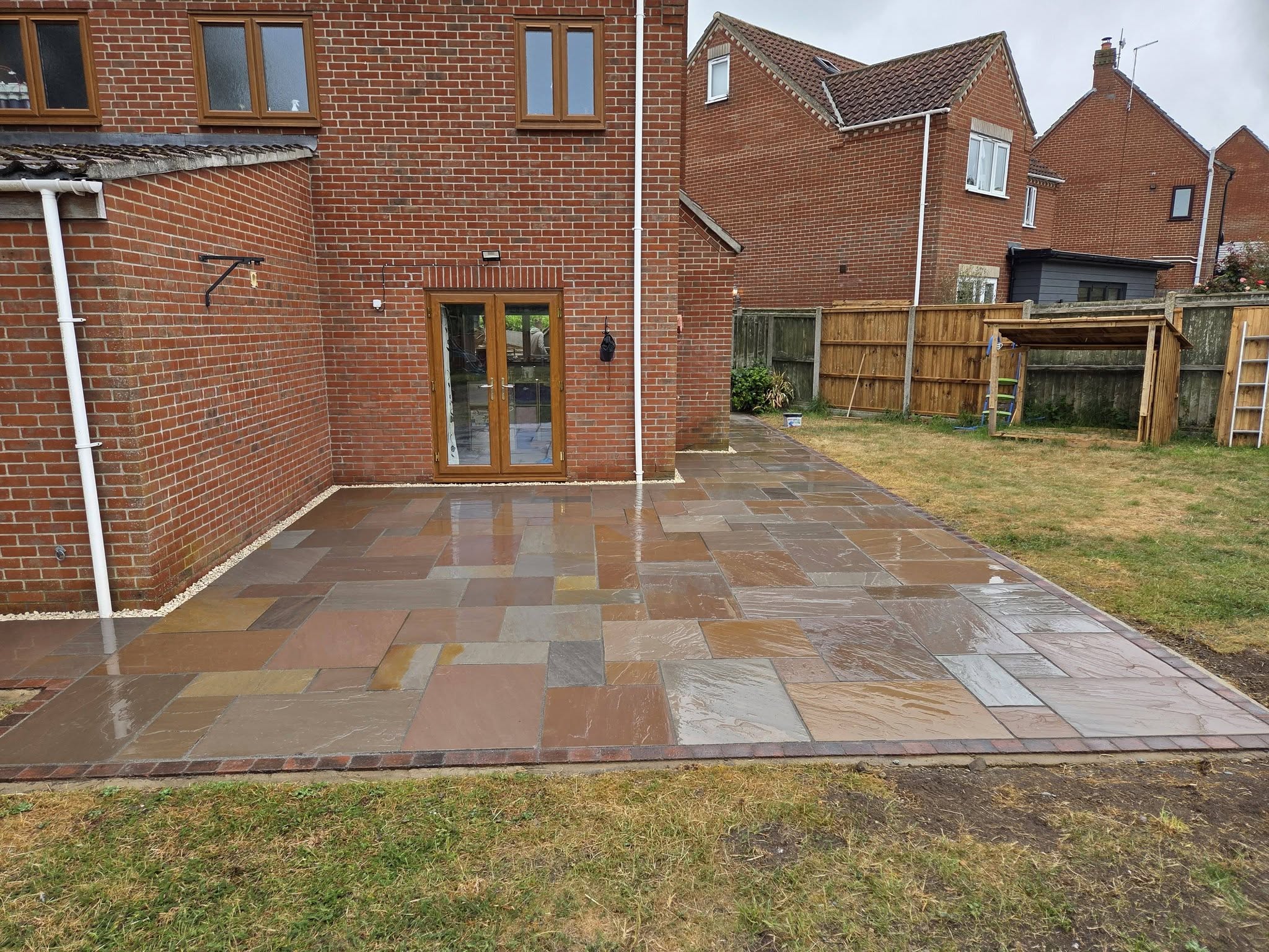 Cawston Autumn Brown sandstone patio with brindle block edging