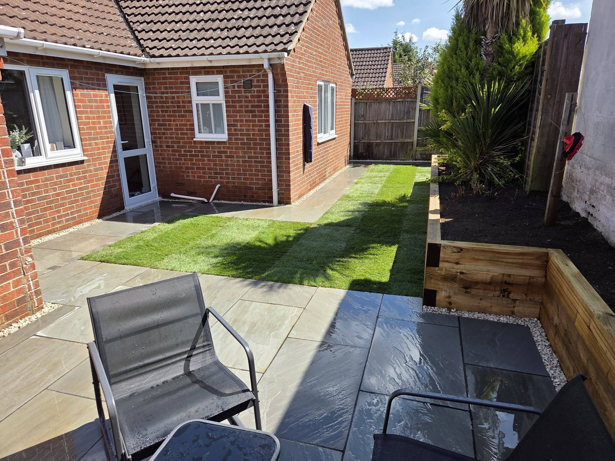 Costessey complete garden transformation — kandla grey patio and sleeper beds