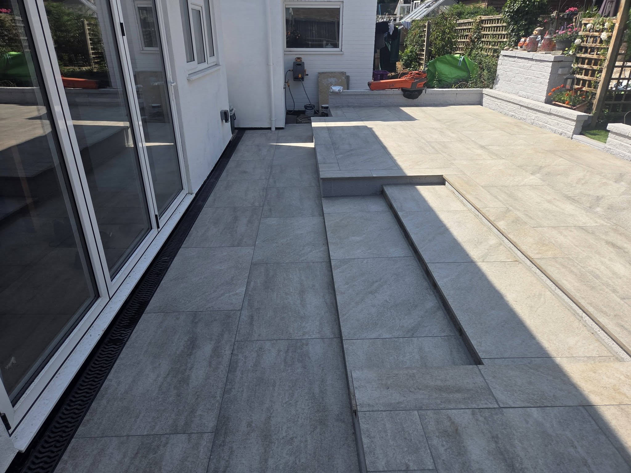 Serenity Grey porcelain patio with built-in steps and ACO drainage