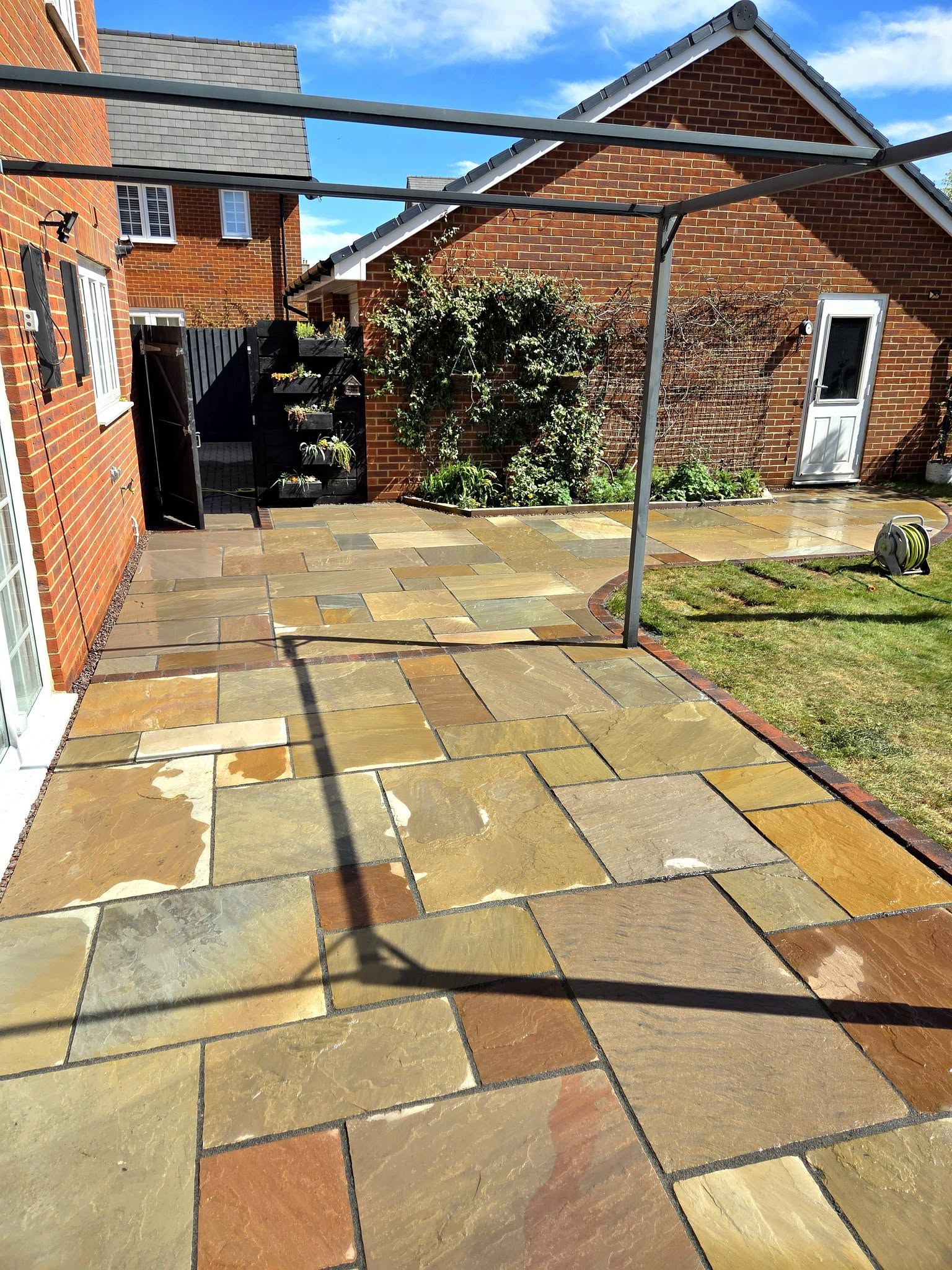Wymondham autumn brown sandstone patio with brindle block edging